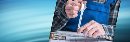 Plumber's hands putting teflon tape on a thread of a plumbing fitting. panoramic bannerの写真素材