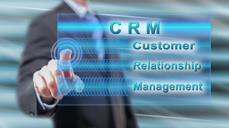 Man touching a crm concept on a touch screen with his fingersの写真素材