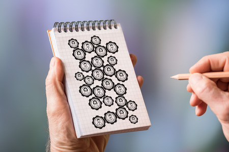 Hand drawing teamwork concept on a notepadの写真素材