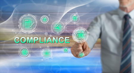 Man touching a compliance concept on a touch screen with his fingerの写真素材