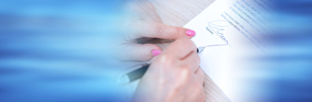 Woman signing a legal document. panoramic bannerの写真素材