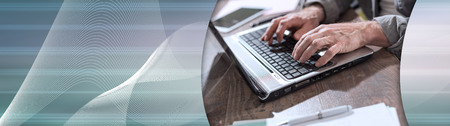 Businessman working on laptop in office. panoramic banner