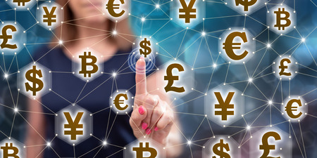Woman touching a currency network concept on a touch screen with her fingerの写真素材
