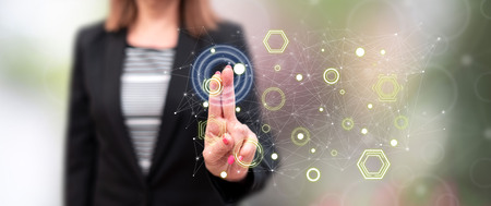 Woman touching a digital network concept on a touch screen with her fingersの写真素材