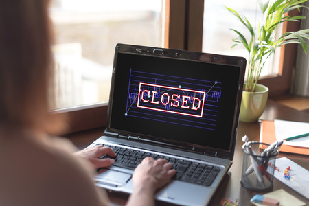 Laptop screen displaying a closed stock market conceptの写真素材