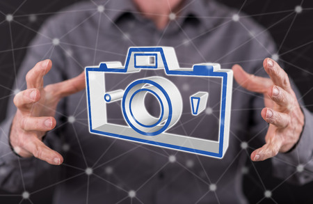 Pictures sharing concept between hands of a man in backgroundの写真素材