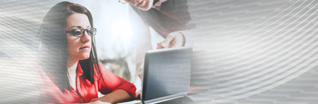 Young businesswoman and senior businessman working together at office, light effect. panoramic...