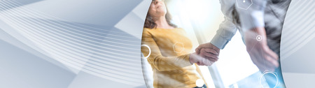 Businesswoman and businessman shaking hands in office, light effect. panoramic bannerの写真素材