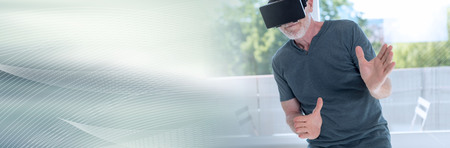 Senior man using a virtual reality headset. panoramic banner