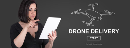 Woman using digital tablet with drone delivery concept on background