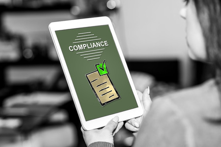Tablet screen displaying a compliance conceptの写真素材
