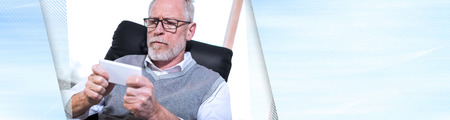 Senior businessman using his mobile phone in office. panoramic banner