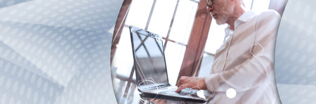 Senior businessman using laptop, hard light effect, double exposure with network. panoramic banner