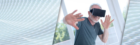Senior man using a virtual reality headset. panoramic banner