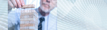 Business development concept by building a tower with domino blocks, double exposure. panoramic...