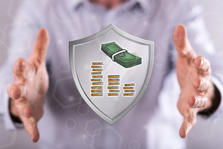 Money protection concept between hands of a man in backgroundの写真素材