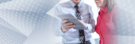 Business people using tablet in office, overlayed with rays. panoramic banner