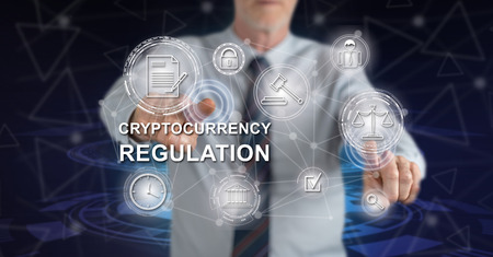 Man touching a cryptocurrency regulation concept on a touch screen with his fingers
