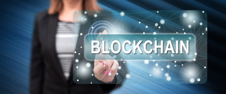 Woman touching a blockchain concept on a touch screen with her fingersの写真素材