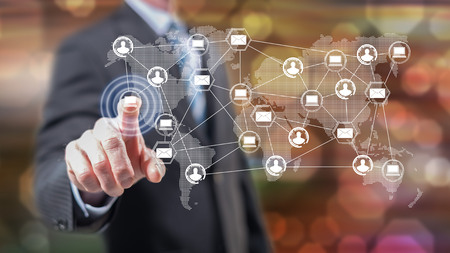 Man touching a global network technology concept on a touch screen with his fingers