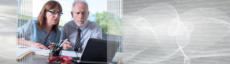 Two mature business people working together in office. panoramic bannerの写真素材