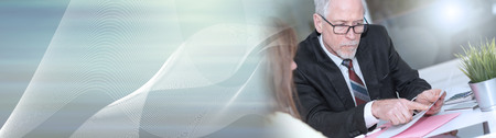Financial consultant giving advices to female client, light effect. panoramic bannerの写真素材