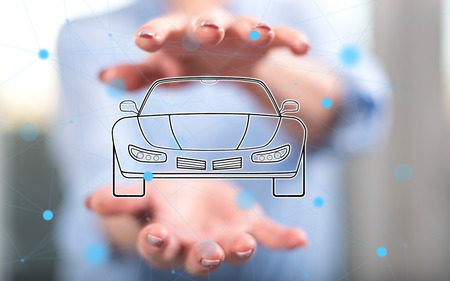 Car transport concept between hands of a woman in backgroundの写真素材