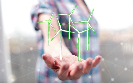 Clean energy concept above the hand of a woman in backgroundの写真素材