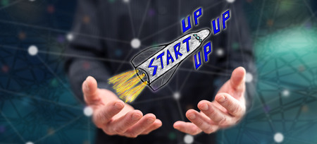 Start up concept above the hands of a man in background