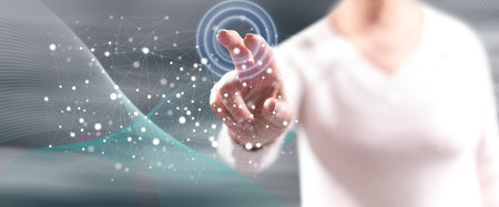 Woman touching a network concept on a touch screen with her fingers