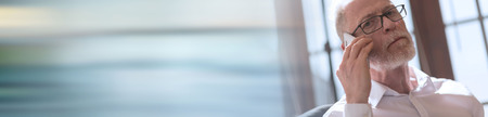 Senior man talking on mobile phone. panoramic bannerの写真素材