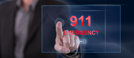 Man touching an emergency concept on a touch screen with his fingerの写真素材