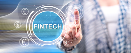 Woman touching a fintech concept on a touch screen with her fingerの写真素材