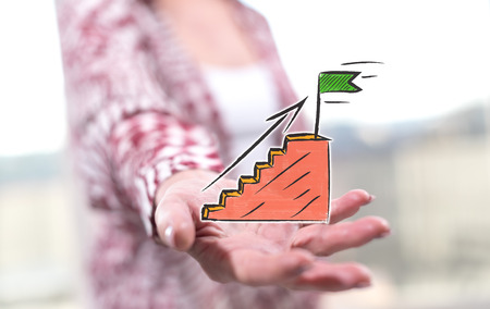 Success concept above the hand of a woman in backgroundの写真素材