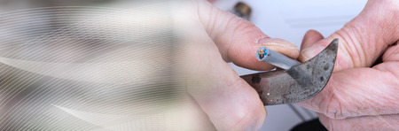 Hand cutting the insulation of a power cable. panoramic bannerの写真素材
