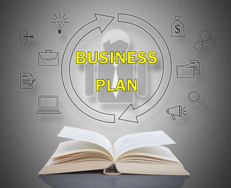 Business plan concept above an open bookの写真素材