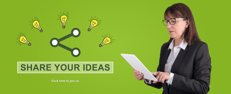 Woman using digital tablet with ideas sharing concept on backgroundの写真素材