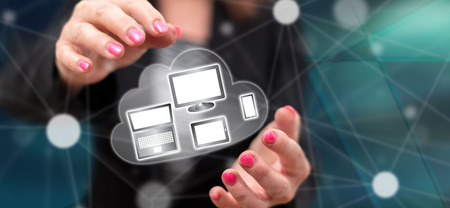 Devices connection concept between hands of a woman in backgroundの写真素材