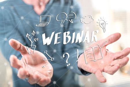 Webinar concept above the hands of a man in backgroundの写真素材