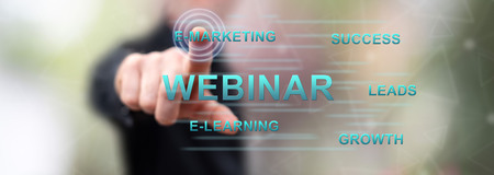 Man touching a webinar concept on a touch screen with his fingerの写真素材