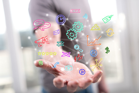 Mobile apps concept above the hand of a man in backgroundの写真素材