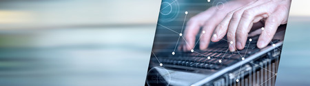 Hands typing on a laptop, overlayed with graphs. panoramic banner