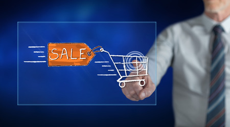 Man touching a sale concept on a touch screen with his fingerの写真素材