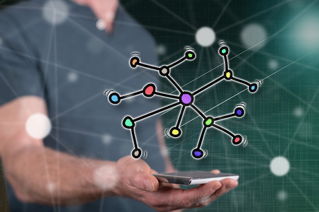 Network concept above a smartphone held by a man in background