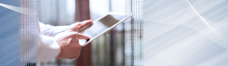 Businessman using tablet, hard light effect. panoramic bannerの写真素材