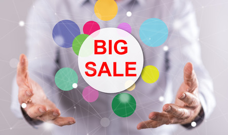 Big sale concept above the hands of a man in backgroundの写真素材