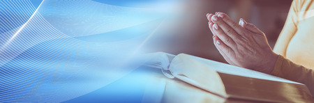 Close up of woman praying with her hands over the bible. panoramic bannerの写真素材
