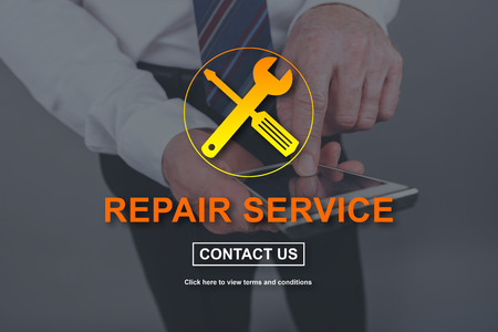Repair service concept illustrated by a picture on backgroundの写真素材