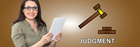 Woman using digital tablet with judgment concept on backgroundの写真素材