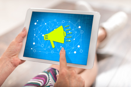 Woman using a tablet with communication network conceptの写真素材